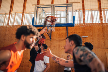 Portrait of an african basketball player dunking the ball into hoop