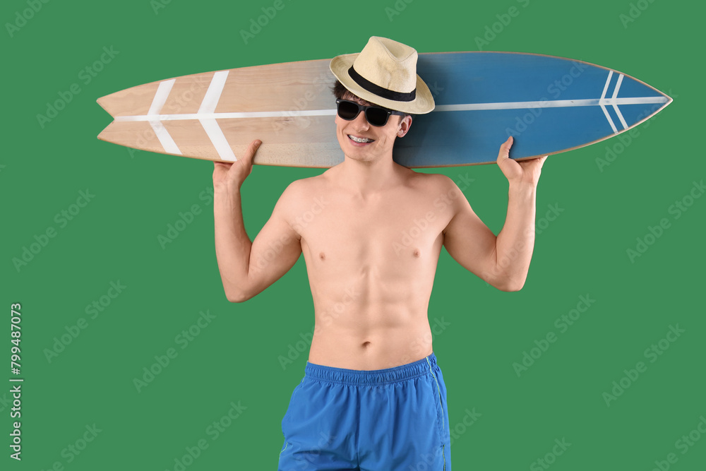 Sticker handsome young happy man with surfboard on green background