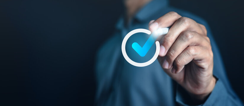 approval, checkbox, management, plan, question, report, satisfaction, checklist, quality, voting. A man is holding a blue check mark in his hand. Concept of approval or satisfaction.
