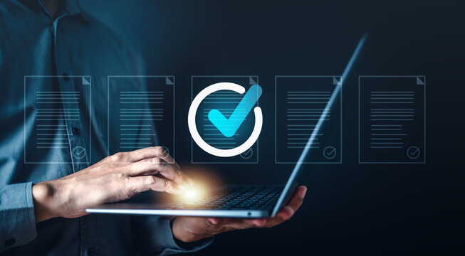 confirmation, communication, validation, process, interface, control, approval, assurance, certificate, certified. A man is typing on a laptop with check mark. represents a successful task.