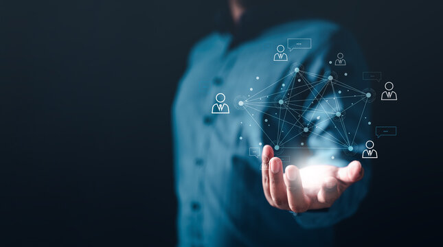 social, network, graph, management, global, marketing, multimedia, team, information, system. A man is holding a glowing network of people on it. Concept of interconnectedness and relationships.