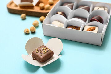 Delicious chocolate candy on blue background