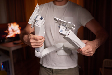 The hands of a young guy installing a computer monitor