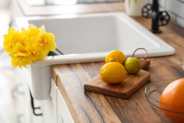 Beautiful bouquet of daffodils in sink in kitchen