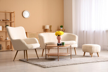 Modern interior of living room with sofa, armchair and daffodil flowers
