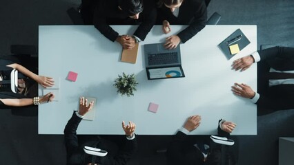 Top down aerial view of professional business team wear vr headset and receive financial data from laptop while use hand gesture to control marketing plan from manager laptop at meeting. Directorate.