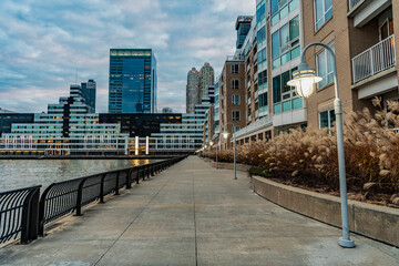 Street lamp on waterfront city promenade. City downtown. Path way in the street with urban...
