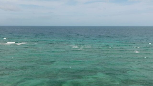 Ocean waves and corals reefs with turquoise water. Blue sea in Santa Fe, Tablas, Romblon. Philippines.