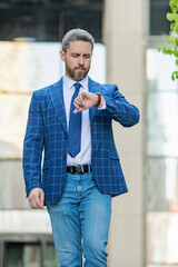 Punctual businessman checking time outdoor. Business deadline. Businessman late for business...