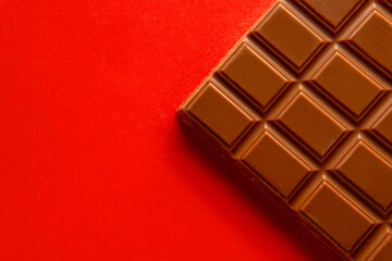 Closeup of a chocolate bar on a red background