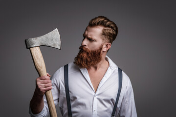 Brutal man in suspenders isolated on grey. Mature redhead man with hairstyle. Brutal male fashion...