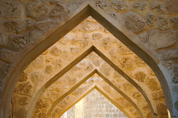 close up View of the stone archway in the ancient fortress of Qal’at Al Bahrain, a UNESCO World...