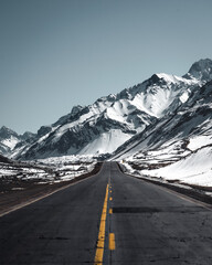 straight road across snowy mountain landscape
