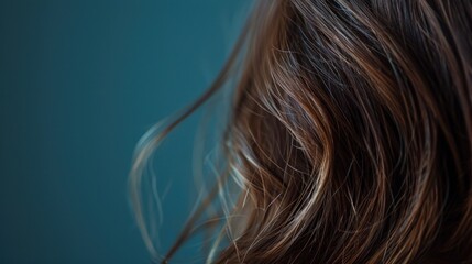 Naklejka premium Natural brown hair on dark blue background,