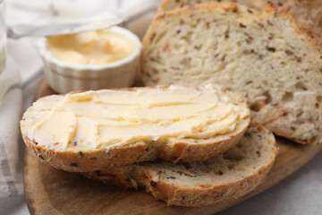 Tasty bread with butter on table, closeup