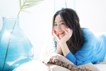 Beautiful woman lying on her cheeks in a prone position Lying down in the summer sun Beauty images of sea and summer tanning and UV