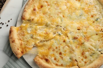 Delicious cut cheese pizza on white table, top view