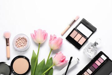 Flat lay composition with different makeup products and beautiful spring flowers on white background