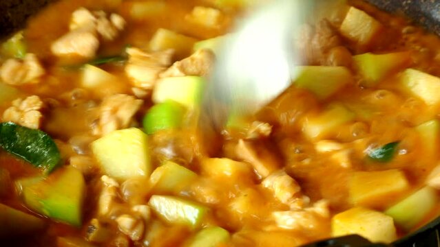Cooking wax gourd chicken curry in pot, in door  Chiangmai  Thailand.