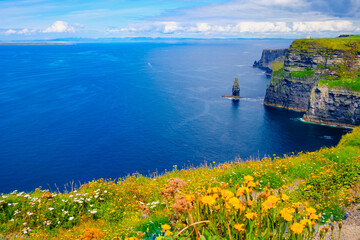 Beautiful view of the Cliffs of Moher, a calm blue sea with copy space.