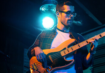 Bass Player In Stage With Colorful Lights