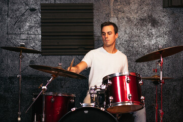 Close-up of a musician playing the drums in a music rehearsal room