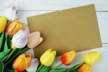 Greeting card mockup space for text message decorations with flowers top view on wooden background