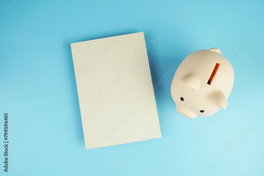 Poster piggy bank saving with space for copy top view on blue background