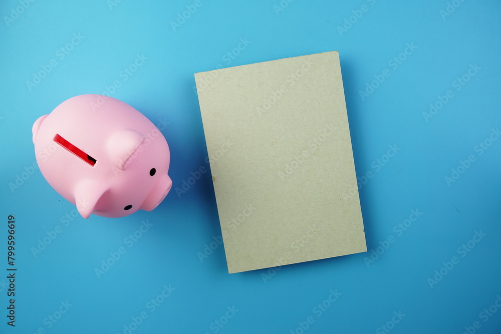 Poster piggy bank saving with space for copy top view on blue background