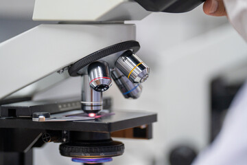 A microscope with a person looking through it