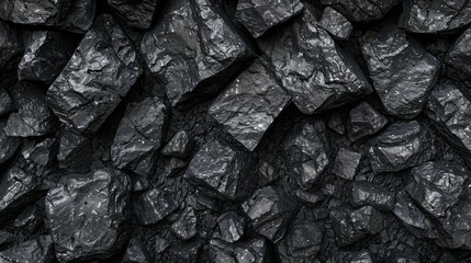 A close up of rough black coal lumps forming a textured pattern