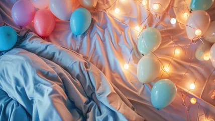 Fotobehang Colorful balloons and twinkling lights on bed with blue linens © Татьяна Макарова