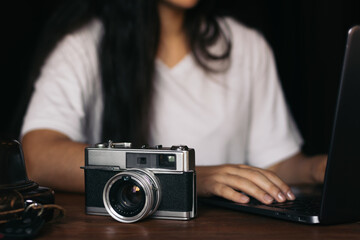 Analog camera and laptop: old and new technology.