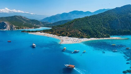 An aerial view showcasing a Mediterranean Sea bay featuring mountains, a sandy beach, and boats on a sunny day during summer.