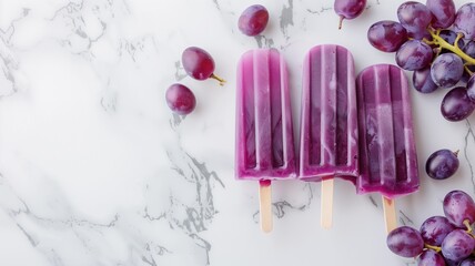 Three purple popsicles with fresh grapes on marble background