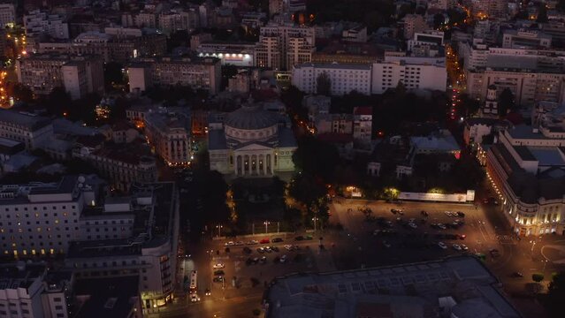 4k high quality aerial footage. Romanian Atene, Concert Hall in the center of Bucharest. Sights of the Romanian capital. Night city lights after sunset. Beautiful historical city in Europe. 