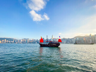 Harmony of Tradition and Modernity: Chinese Junk Sailing Amidst Hong Kong’s Skyline