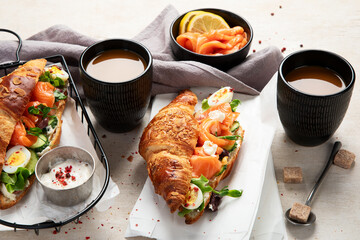 Freshly cooked homemade croissant sandwich with natural salmon fish.