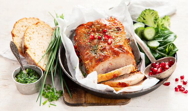 Sliced baked ham with salad on light wooden background. Traditional food concept