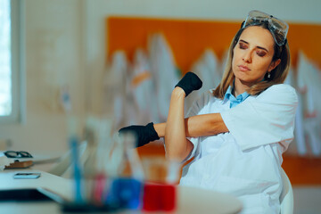 Tired Scientist Stretching her Arms Working in the Lab. Sad overworked research worker trying to...