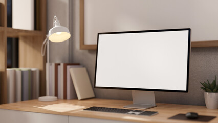 A close-up image of a computer mockup on a wooden desk in a contemporary minimalist home office.