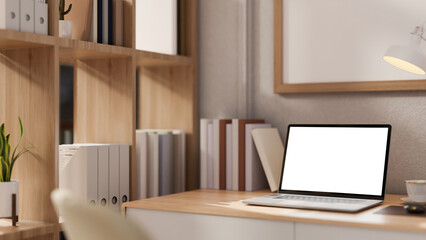 A close-up image of a laptop mockup on a wooden desk in a contemporary minimalist home office.