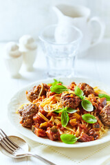  Spaghetti Pasta with Meatballs and fresh Basil o bright background. Close up.