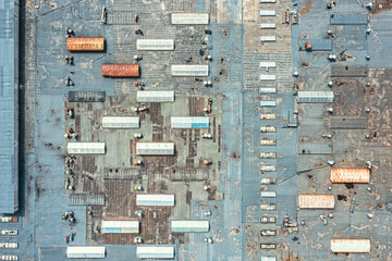 weathered roof of large industrial building or distribution warehouse. industrial background. aerial top view.