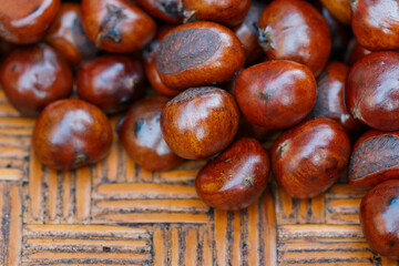 Chestnuts on woven wooden trays for sale at the market
