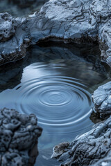 The rhythmic patterns of ripples in a tranquil rock pool, with the gentle movement of water creating a mesmerizing minimalist composition that invites contemplation.