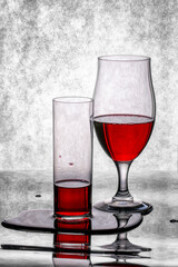 Glasses with red wine on a black and white background