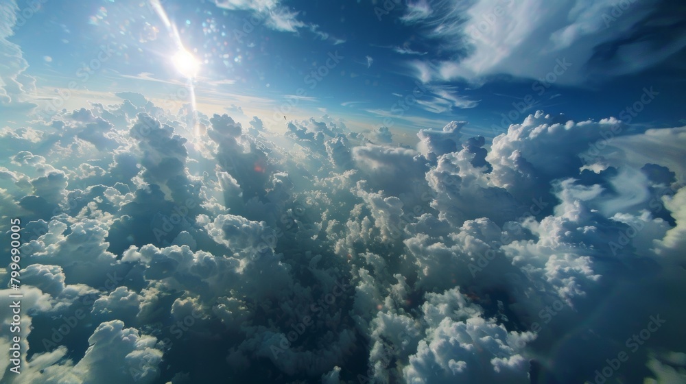 Poster the sun can be seen shining brightly above a layer of fluffy clouds in the sky. the rays of sunlight
