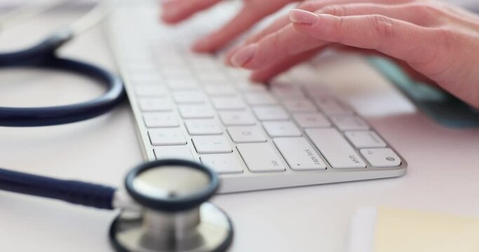 Doctor is typing on computer keyboard