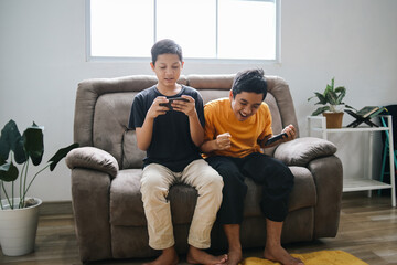 Two Young Friends Playing E Sport Gaming Using Smartphone. One Boy Focus Playing Online Games,...